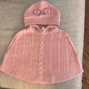 Pink knit cable sweater poncho